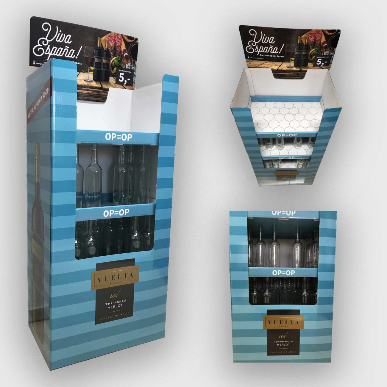 Blue striped wine display stand with open shelves showing empty and partially filled bottles and a 'OP=OP' label at the front edge, brand Vuelta Rioja red wine poster on top left.