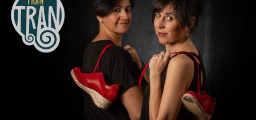 Two women in black, back-to-back, with red sneakers dangling from their shoulders against a dark backdrop; a TRAN TRAN logo appears on the left.